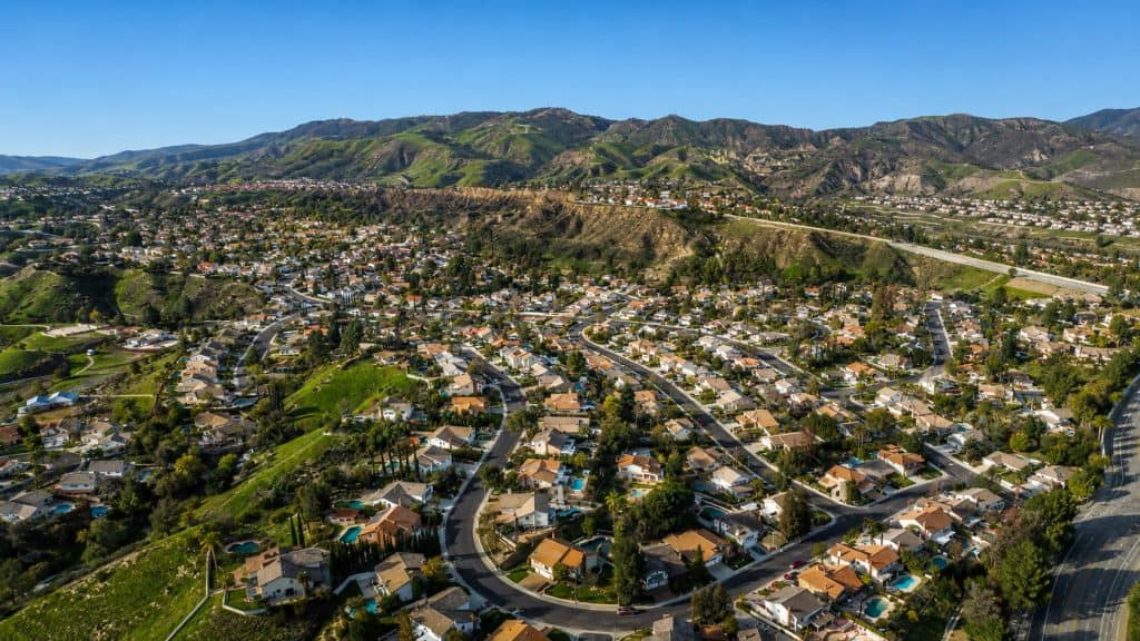 Aerial view of Porter Ranch homes, winding streets, and scenic hills in 91326